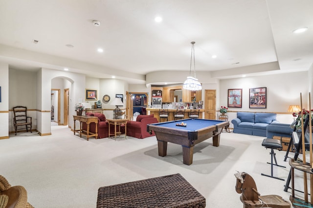 recreation room with pool table, bar area, and light colored carpet