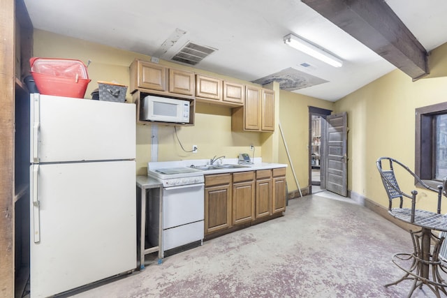 kitchen with beamed ceiling, sink, and white appliances