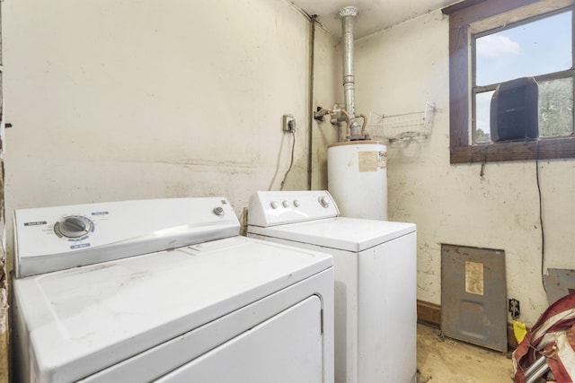 clothes washing area featuring gas water heater and washing machine and clothes dryer