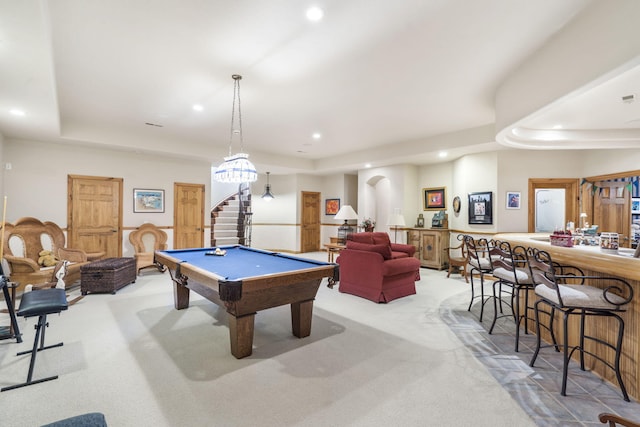 rec room featuring billiards, a tray ceiling, and light colored carpet