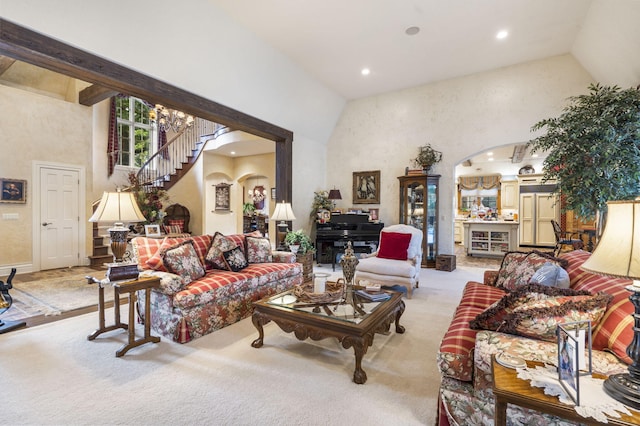 living room featuring light carpet and high vaulted ceiling