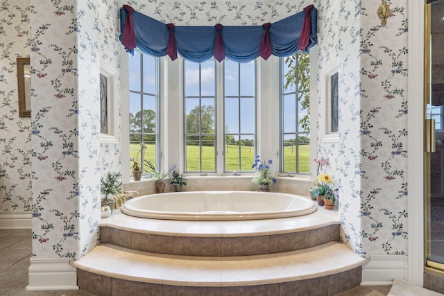 bathroom with tile patterned floors and tiled tub