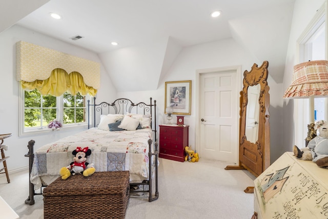 bedroom featuring light carpet and vaulted ceiling