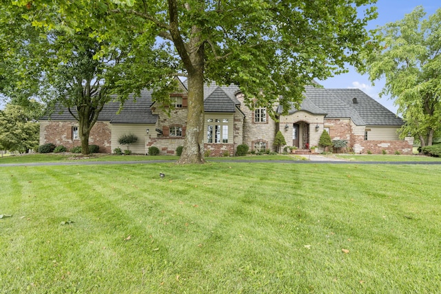 french country style house featuring a front yard