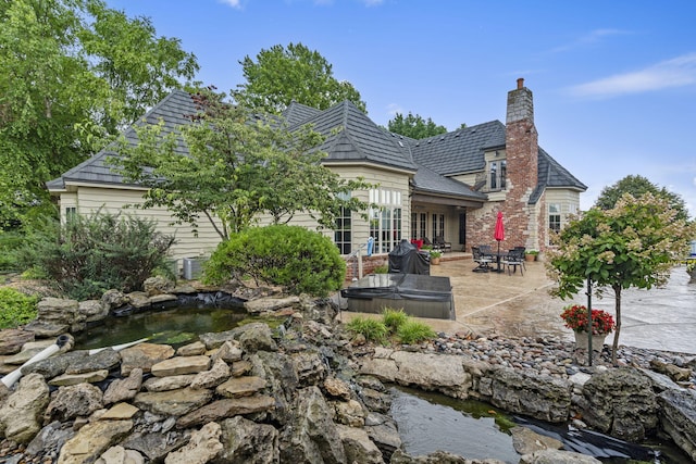 back of house with a patio