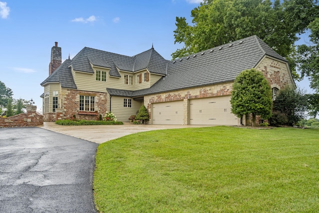 view of front of house with a front yard and a garage