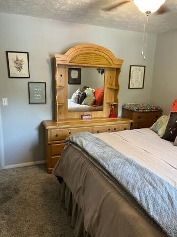 carpeted bedroom featuring a textured ceiling and ceiling fan