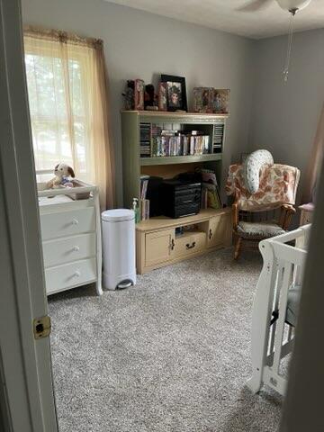 sitting room with carpet flooring and ceiling fan