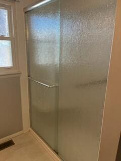 bathroom with a shower with shower door