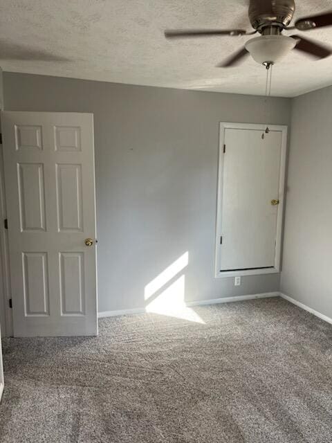 spare room with ceiling fan, a textured ceiling, and carpet floors