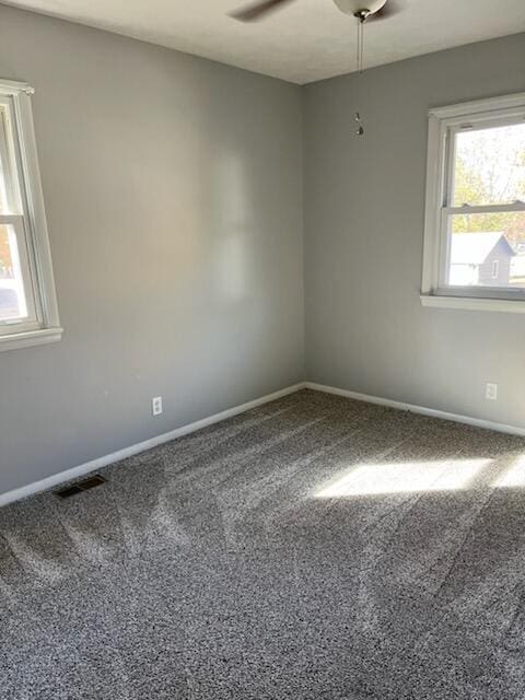 unfurnished room with carpet and ceiling fan