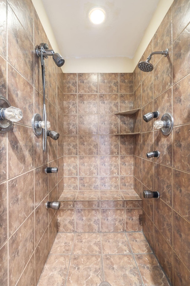 bathroom with a tile shower