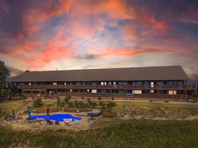 outdoor building at dusk featuring a community pool