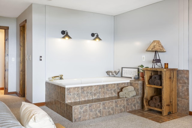 bathroom with tiled bath and tile patterned flooring