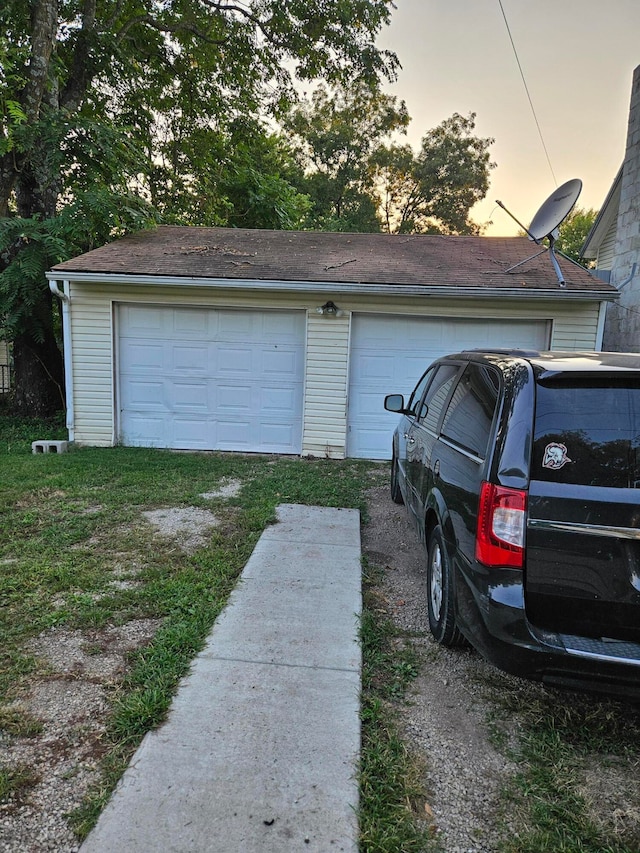 view of garage at dusk