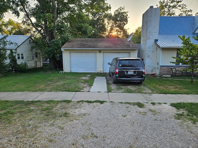 garage at dusk with a lawn