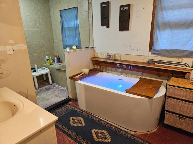 bathroom featuring vanity and tile walls