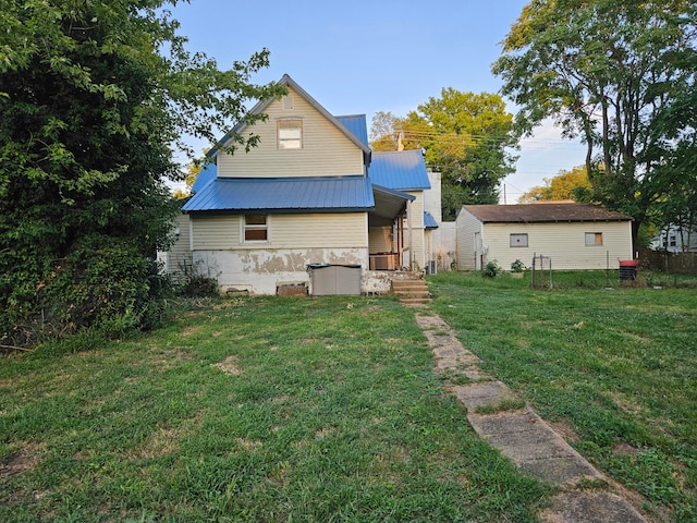 rear view of house with a lawn