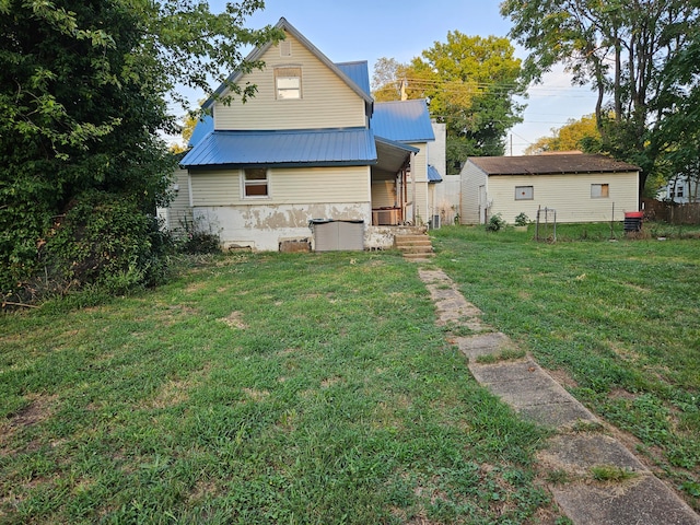 rear view of property with a yard