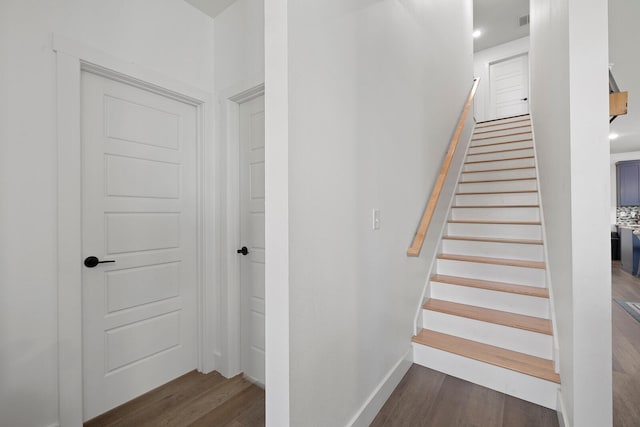 staircase featuring hardwood / wood-style flooring