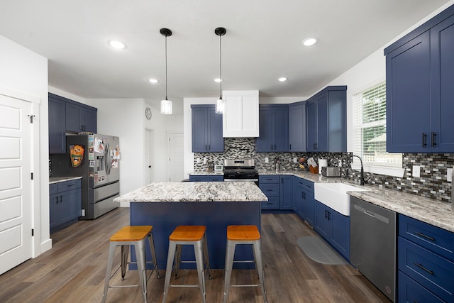 kitchen featuring a kitchen island, dark hardwood / wood-style floors, sink, and stainless steel appliances