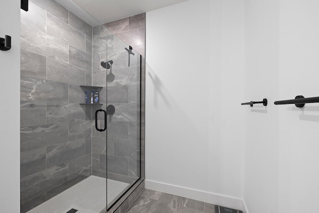 bathroom featuring a shower with shower door