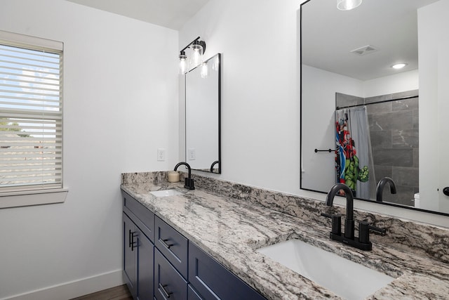 bathroom featuring walk in shower, wood-type flooring, and vanity