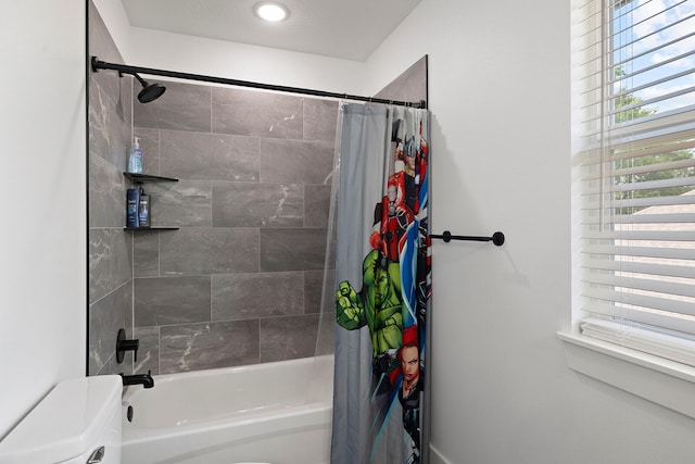 bathroom with toilet and shower / bathtub combination with curtain