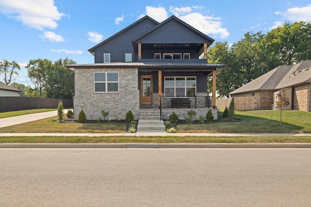 craftsman house featuring a front lawn and covered porch