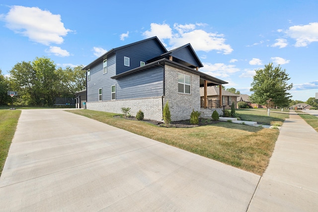 view of home's exterior with a porch and a yard