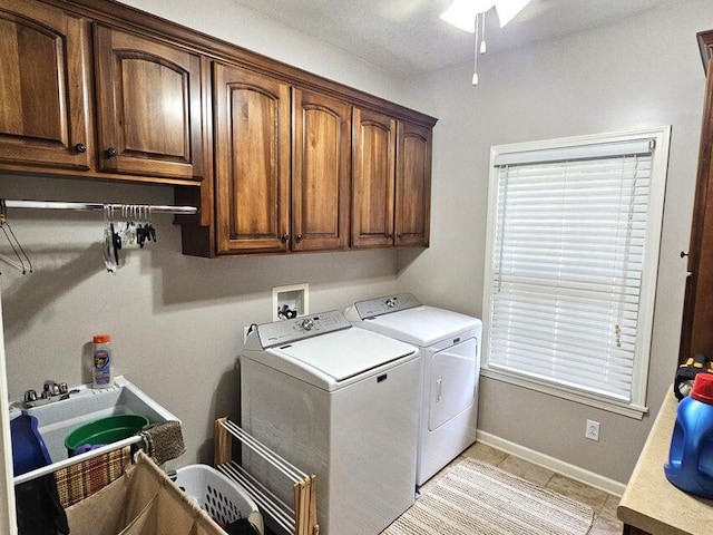 washroom with ceiling fan, sink, cabinets, washing machine and dryer, and light tile patterned floors