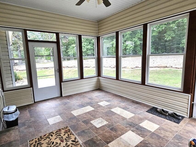 unfurnished sunroom featuring plenty of natural light and ceiling fan