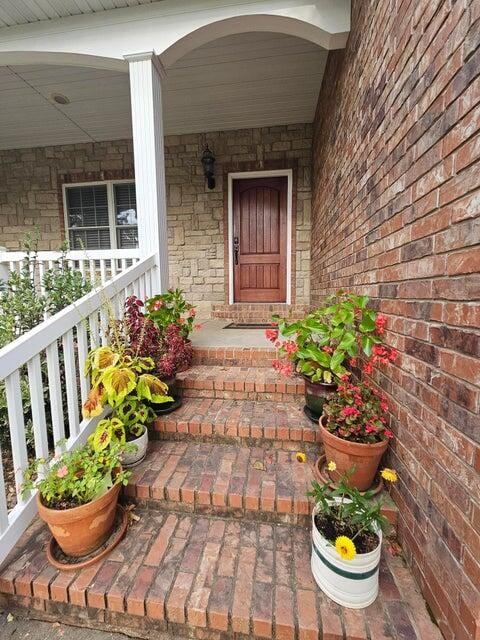 doorway to property featuring covered porch