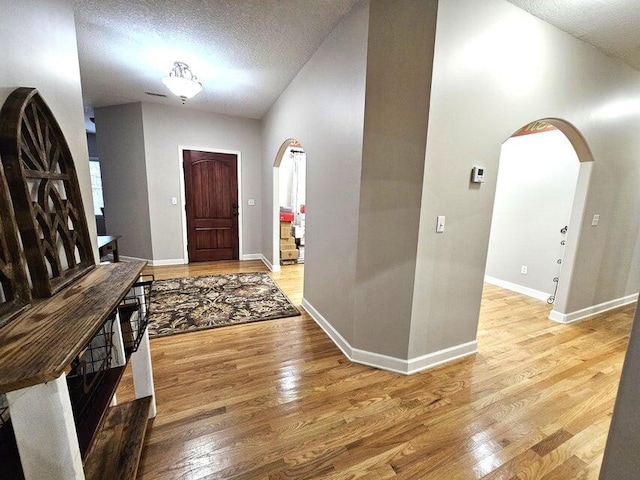 foyer with light hardwood / wood-style floors and a textured ceiling