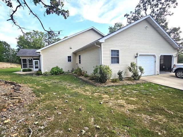 view of property exterior with a garage and a yard