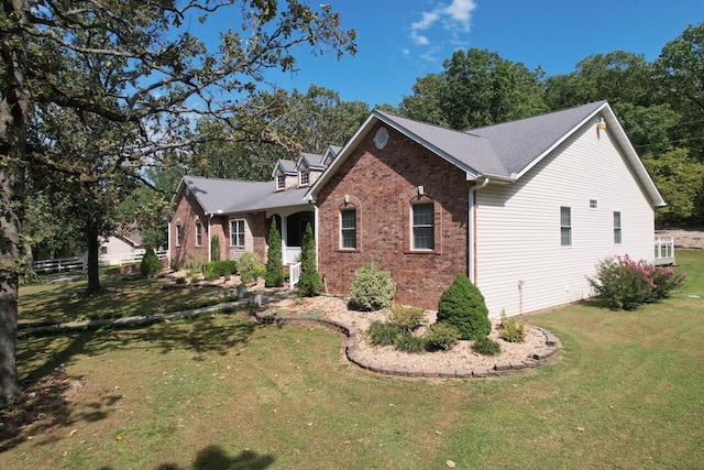 view of side of home with a lawn