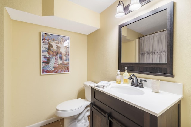 bathroom with vanity, toilet, and tile patterned floors