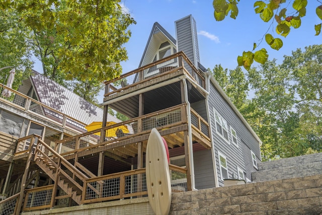 back of house with a wooden deck