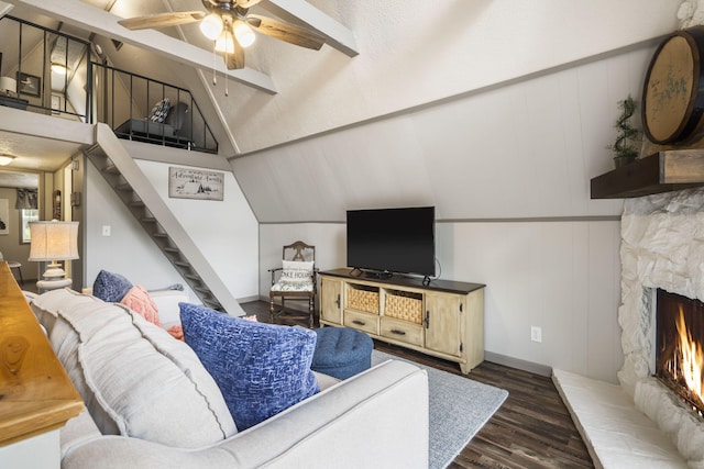 living room featuring ceiling fan, a fireplace, lofted ceiling with beams, and dark hardwood / wood-style flooring