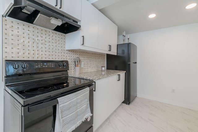 kitchen with light stone countertops, white cabinetry, black appliances, and tasteful backsplash