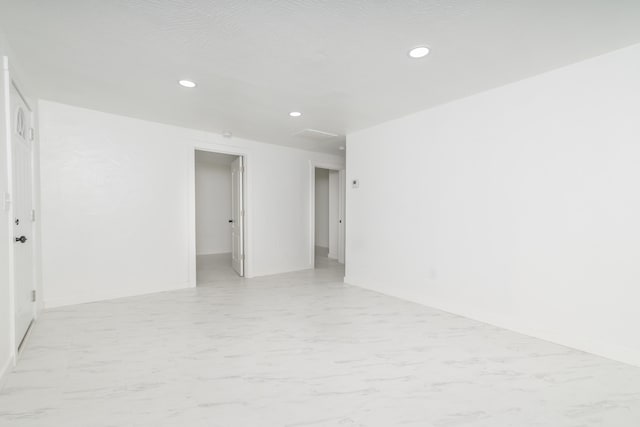 unfurnished room featuring a textured ceiling