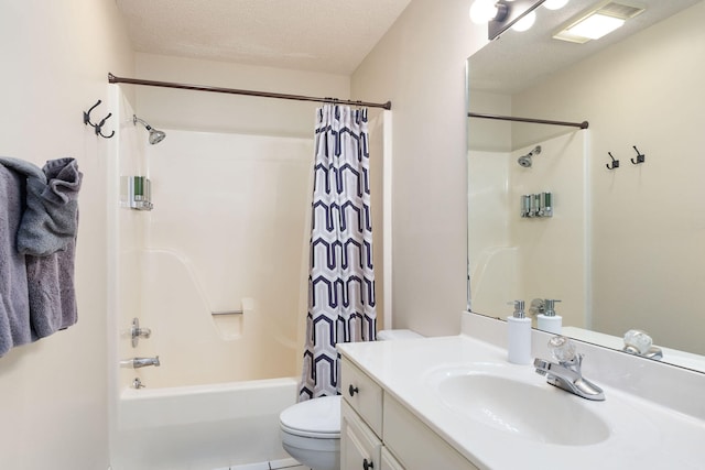 full bathroom featuring vanity, shower / bath combo with shower curtain, toilet, and a textured ceiling