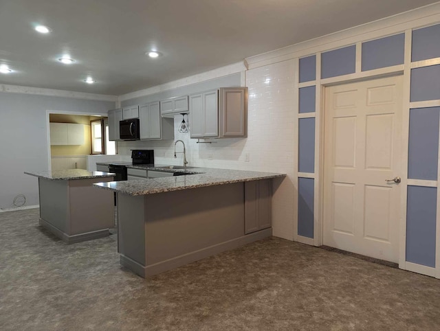 kitchen with gray cabinets, dark colored carpet, kitchen peninsula, and black appliances