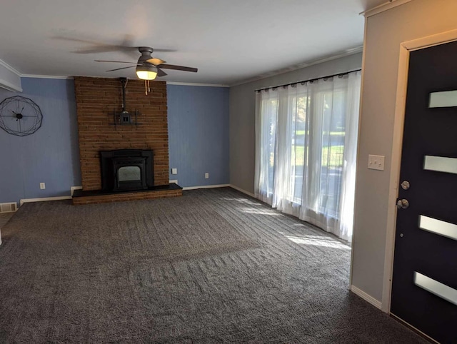 unfurnished living room with a brick fireplace, ornamental molding, carpet, and ceiling fan