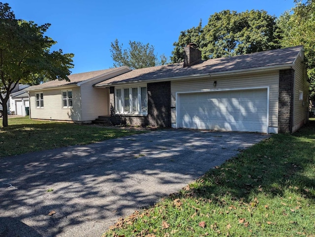 ranch-style house with a garage and a front lawn