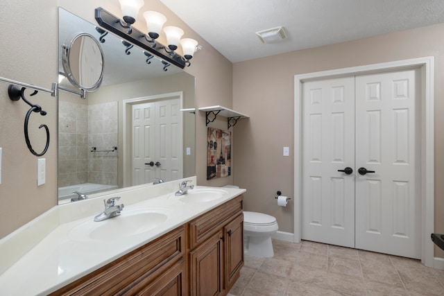 full bathroom with washtub / shower combination, vanity, toilet, and tile patterned floors