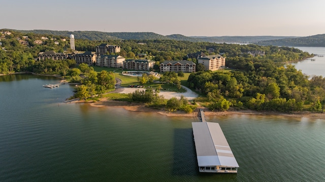 aerial view at dusk featuring a water view