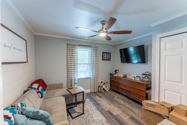 living room featuring crown molding, ceiling fan, and hardwood / wood-style floors