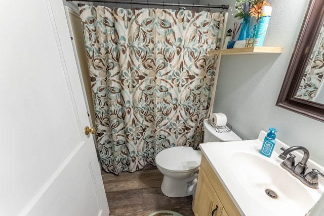 bathroom featuring hardwood / wood-style floors, a shower with shower curtain, vanity, and toilet