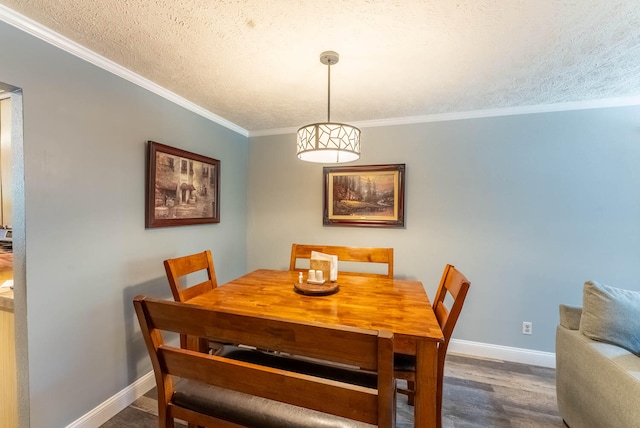 dining room with a textured ceiling, crown molding, and dark hardwood / wood-style flooring